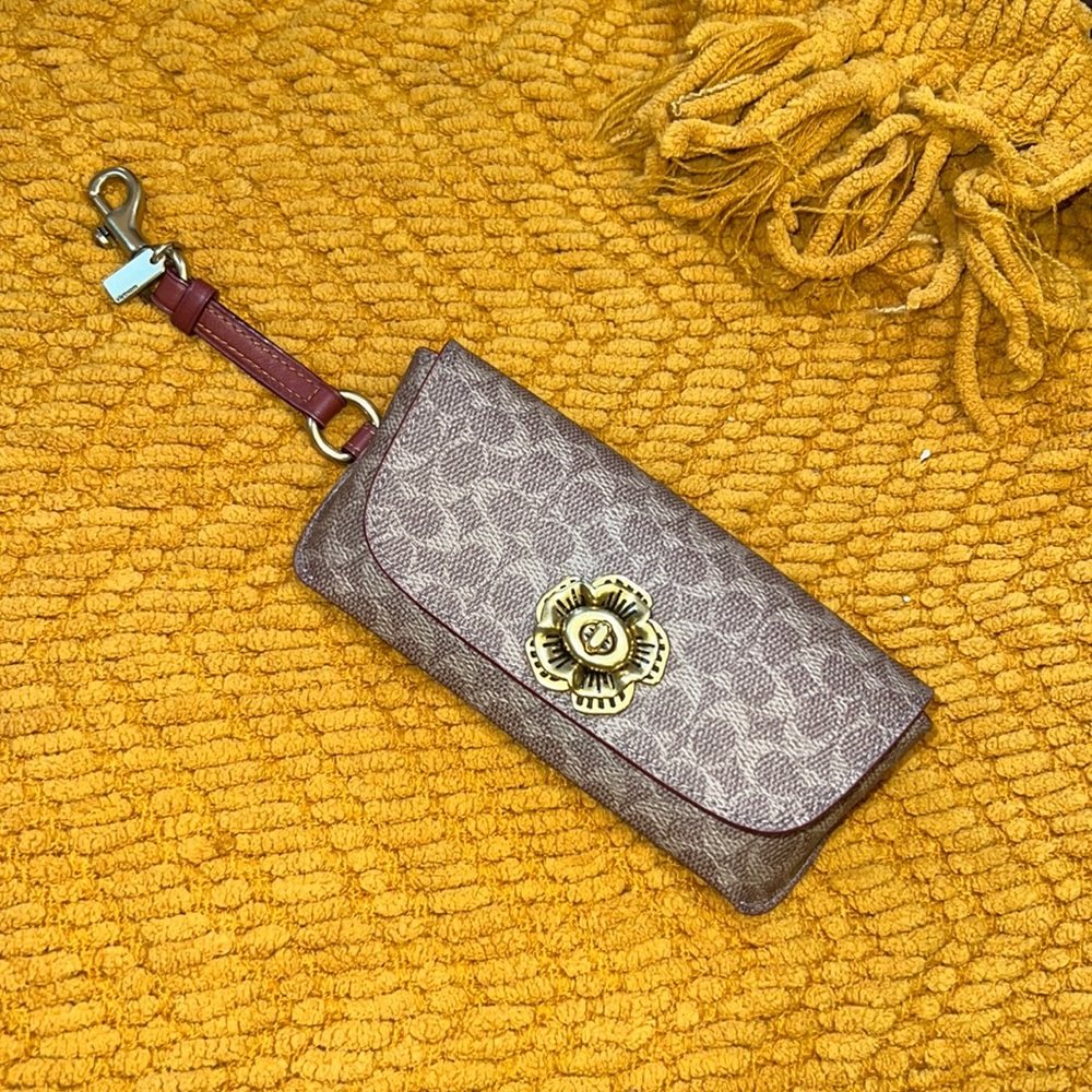 Coach Sunglass Case Signature Canvas in gold and khaki. Attached dogleash clip.